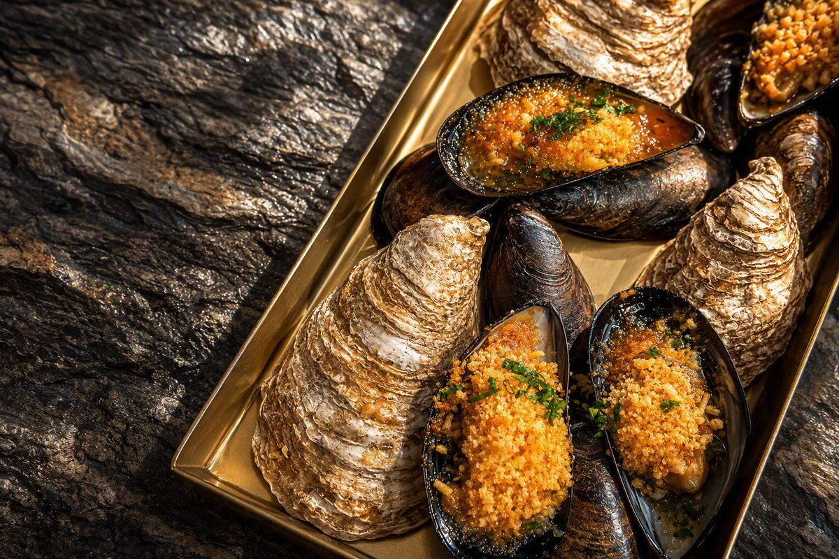 Comparti baked oysters served on a golden tray
